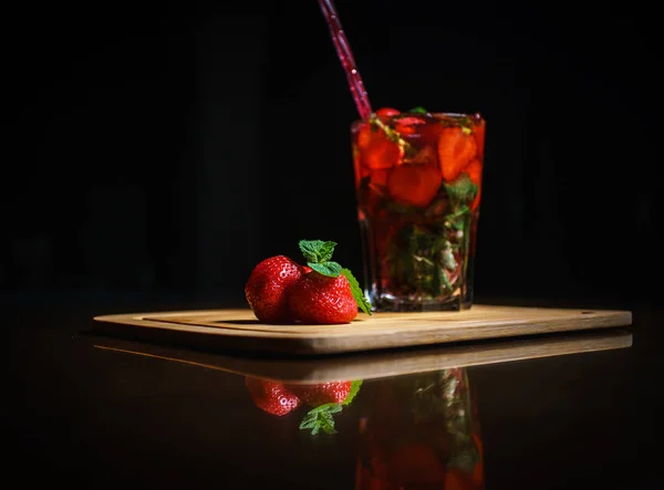 Fresh cocktail on a black background. Alcoholic cocktail on a black background. Fruit with a cocktail. Non-alcoholic cocktail. Mix of cocktails on a black background.