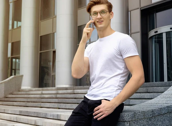 young guy talking over mobile phone