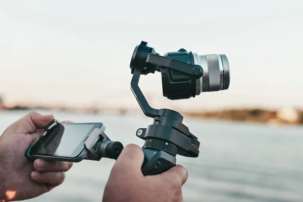 Professional record. Videography. Hand with smartphone and cinematic digital equipment. Record device. Camera stabilizer
