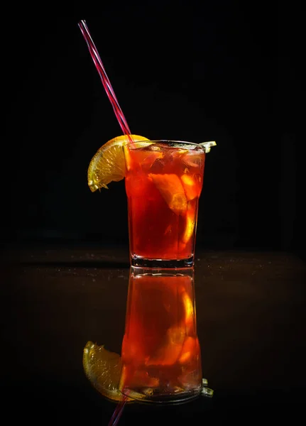 Fresh cocktail on a black background. Alcoholic cocktail on a black background. Fruit with a cocktail. Non-alcoholic cocktail. Mix of cocktails on a black background.