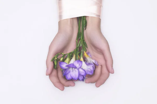 woman hands with flowers top view