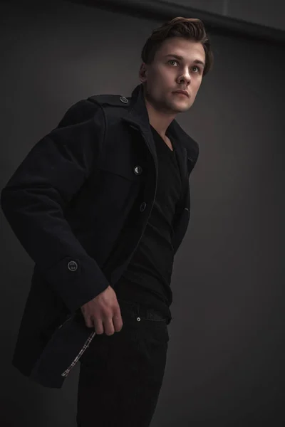 Young Stylish Man Posing Gray Background Wearing Black Coat — Stockfoto