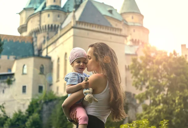 Kiss each other on the background of a beautiful castle. Stock Image