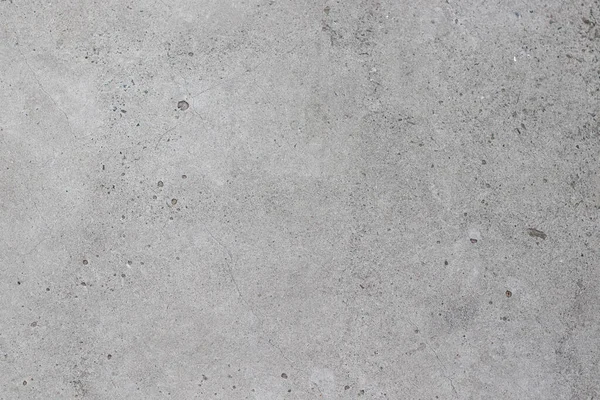 Küçük noktalar ve çatlaklar olan beton gri doku.