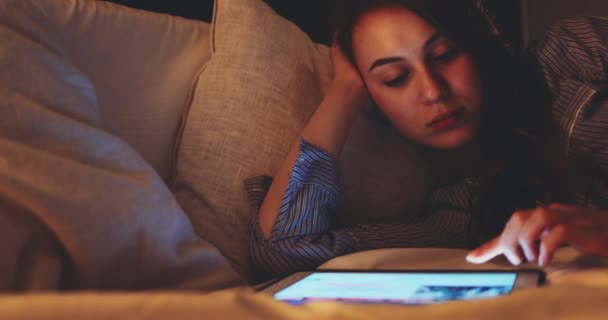 晚上使用平板电脑的女人 慢速移动4K Dci 年轻的千年消费者从家里网上购物 躺在床上 日常生活中的技术 — 图库视频影像