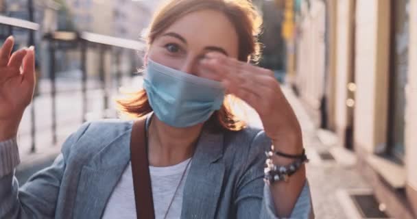 Portrait Of A Woman Wearing A Protective Mask Walking In The City, Goofing Arond . SLOW MOTION Gimbal Stabilizer. Young Female being funny in a face mask against air pollution and coronavirus covid-20
