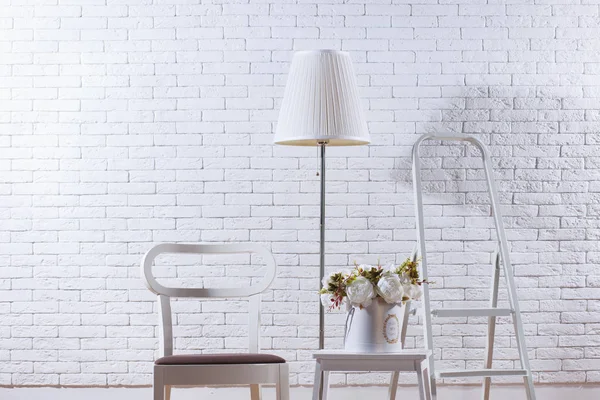 White loft interior with furniture and brick wall