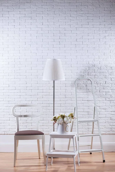Loft interior with white brick wall and furniture