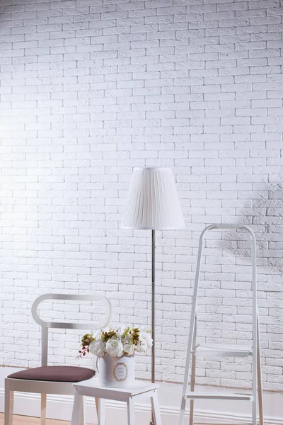 House decor in front of white brick wall, mockup concept