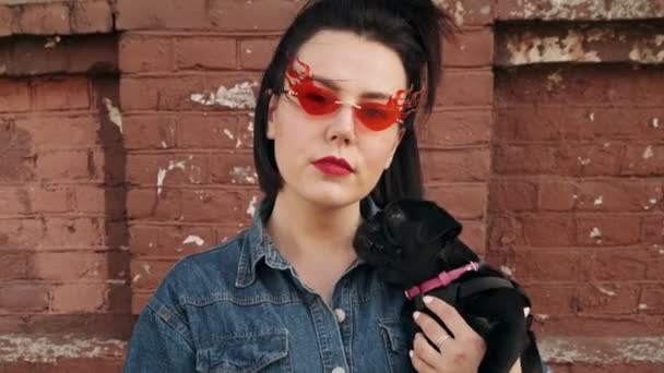 Stylish Woman Fashionable Red Glasses Looks Camera Black Dog Pug — Stock Video