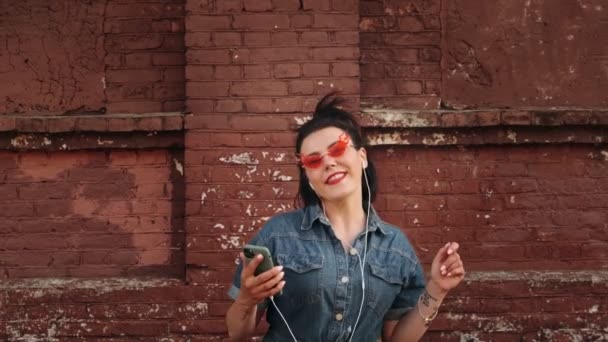 Stylish Hipster Woman Using Mobile Phone Touch Screen Listening Music — Stock Video