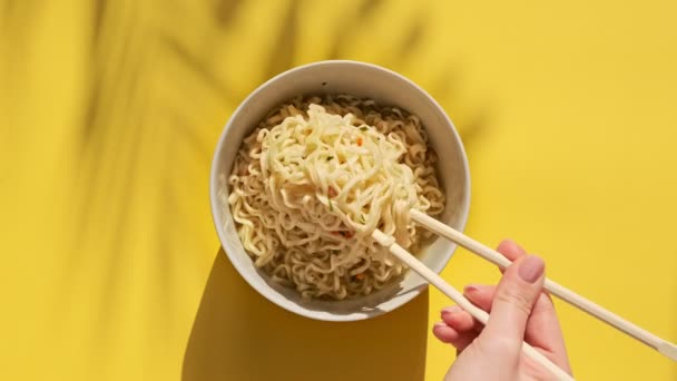 Los Fideos Instantáneos Mezclan Con Palillos Chinos Sobre Fondo Amarillo — Vídeo de stock