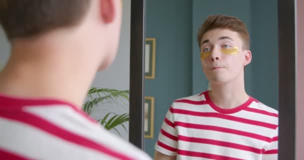 Young Transgenger Guy Does Morning Beauty Routine Standing Front Mirror — Stock Video