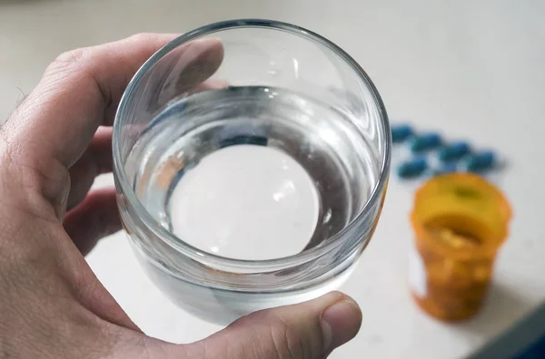Man Håller Med Vänster Hand Ett Glas Vatten Bredvid Piller — Stockfoto