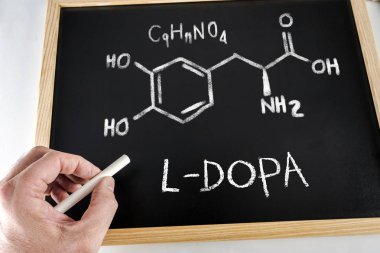 Chemical Formula and nomenclature of L-DOPA handwritten with chalk on a blackboard, conceptual image clipart