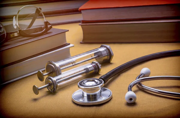 Medicine Books Next To Syringes Vintage And Stethoscope, Concept Of Medicine