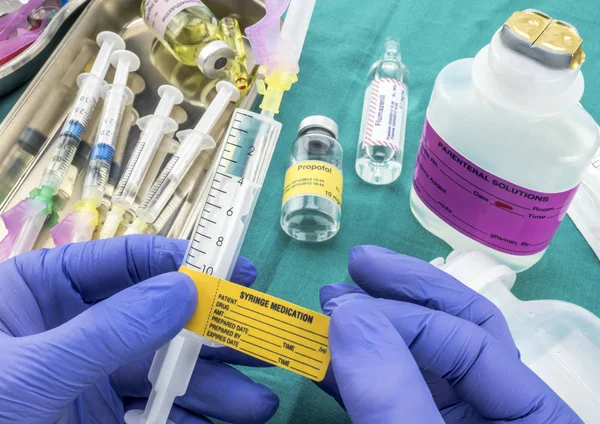 Nurse preparing hospital medication, needle safety closure, conceptual image, horizontal composition