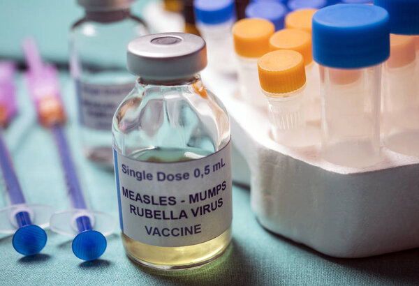 Different vials of triple viral vaccine of measles, rubella and mumps, known as MMR, conceptual image
