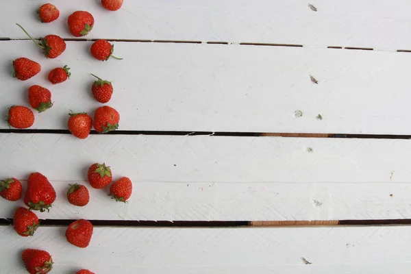 delicious wild fruits on white wooden backgroun