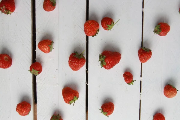 delicious wild fruits on white wooden backgroun