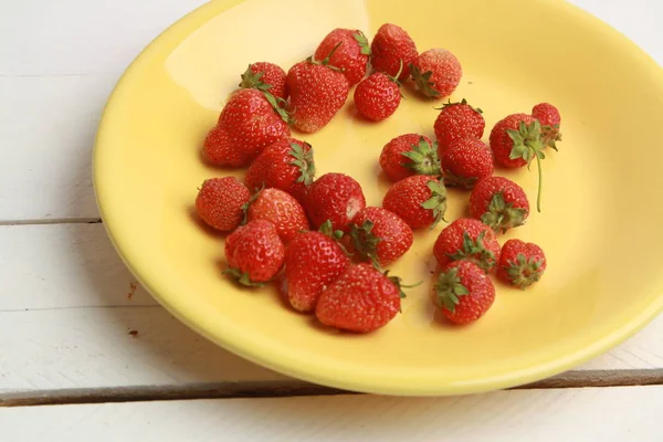 delicious wild fruits on white wooden backgroun