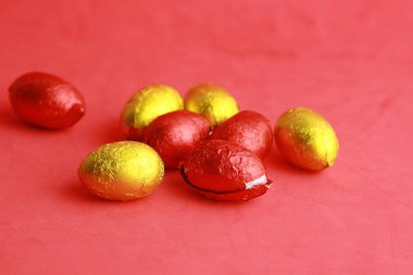 çikolata paskalya yumurtaları, sarı ve kırmızı kağıt sarılmış