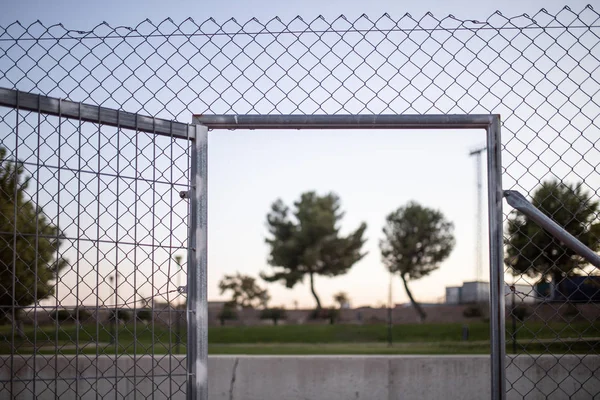 Wire fence at sunset with unfocused background — Stock Image Wire Fence Sunset Unfocused Background Stock Picture