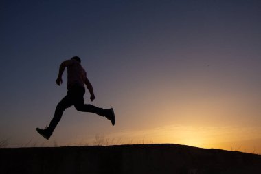 silhouette of man running at sunrise