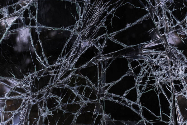 Broken glass texture with cracks closeup, macro