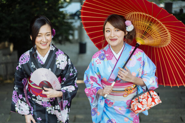 Two beautiful girls with traditional dress walking outdoors