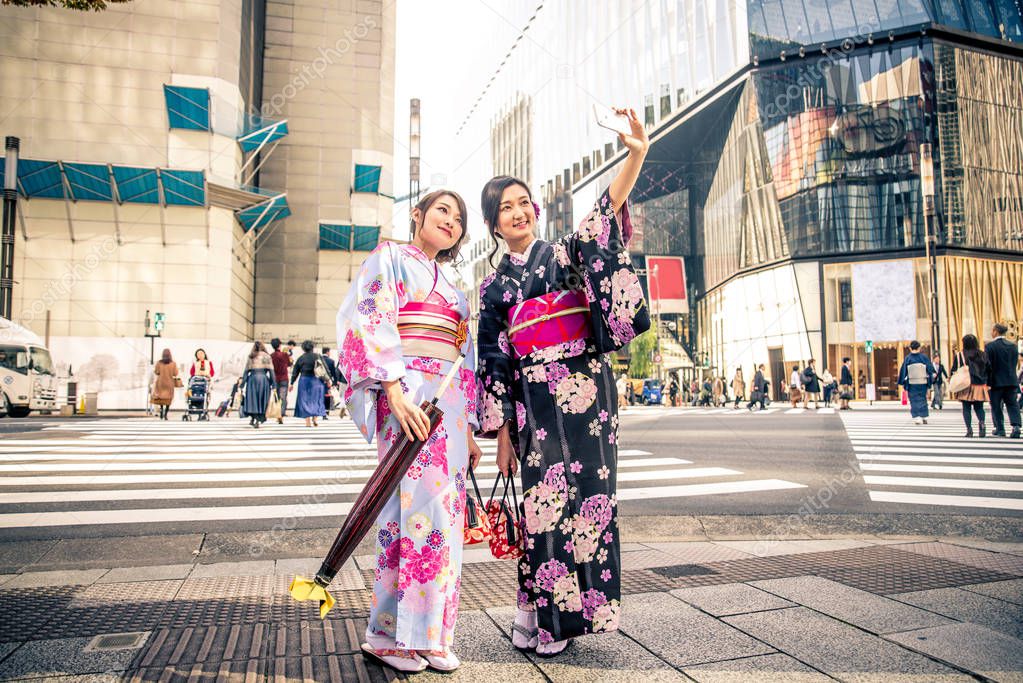Two beautiful girls with traditional dress walking outdoors