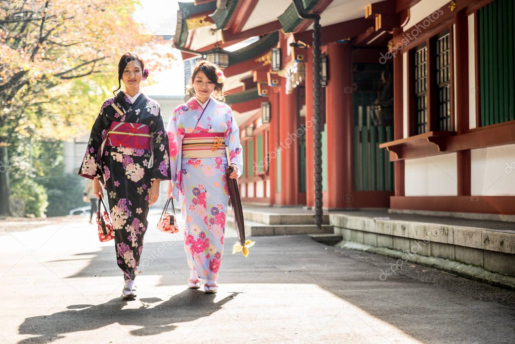 Two beautiful girls with traditional dress walking outdoors