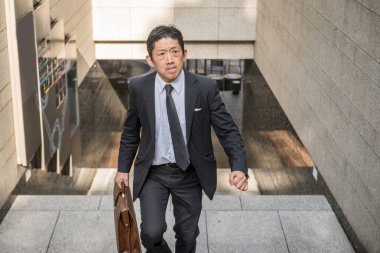 Japon işadamı yürüyüş açık havada - Asya adam şık takım elbise