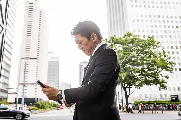 Japanese businessman walking outdoors - Asian man with elegant suit