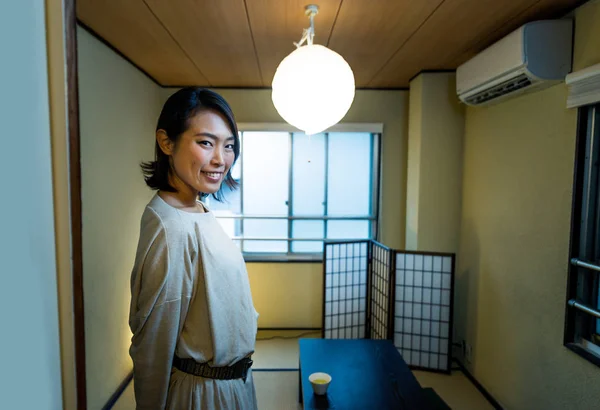 Pretty japanese woman in a traditional Tokyo apartment