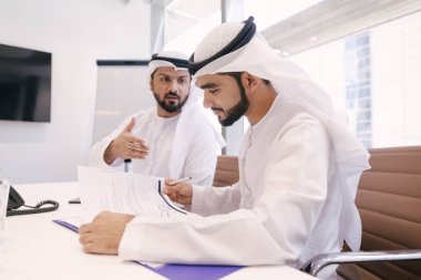 Arabian men meeting and talking about business - Businessmen portrait in Dubai clipart