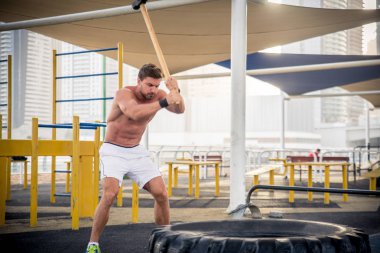 Genç atletik eğitim açık havada - Genç Yetişkin bir fitness egzersiz yapıyor adam