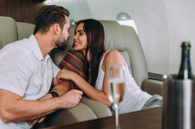Couple on vacation, flying on their private jet clipart