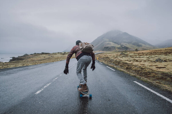 Skater traveling iceland on his longboard