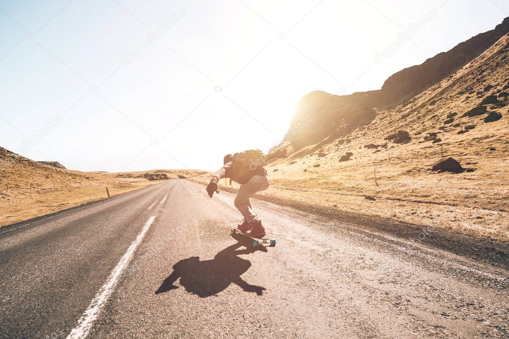 Skater traveling iceland on his longboard