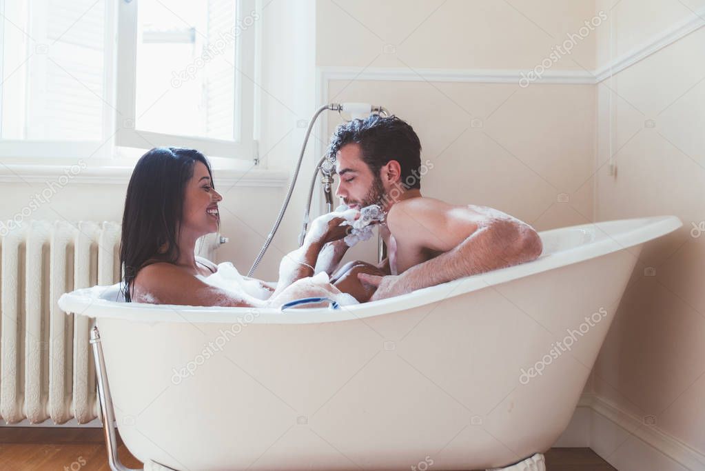Couple in love spending time together in the house. Romantic moments in the bathroom