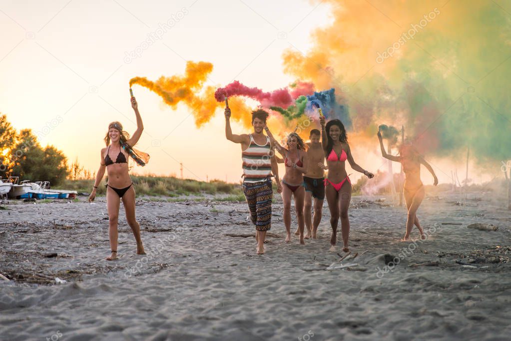 Happy group of friends celebrating and having fun on the beach - Young people on summer holiday