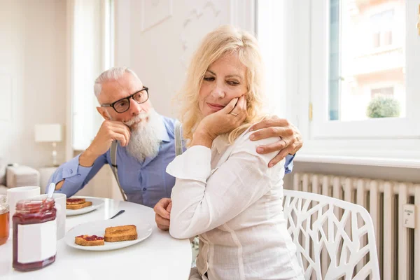 Unhappy senior couple at home