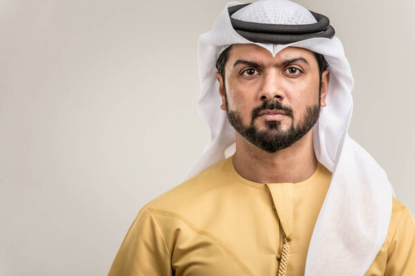 Portrait of arabic man with kandora in a studio