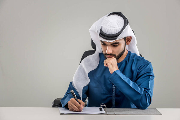 Portrait of arabic man with kandora in a studio