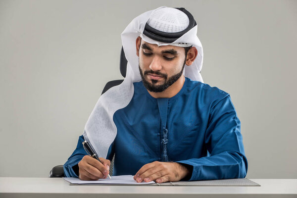 Portrait of arabic man with kandora in a studio