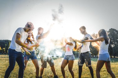 Holi ile oynarken mutlu arkadaş grubu bir parkta - Genç Yetişkin eğlenceli, eğlenceli ve genç nesil hakkındaki kavramları bir holi Festivali, eğleniyor renkler.