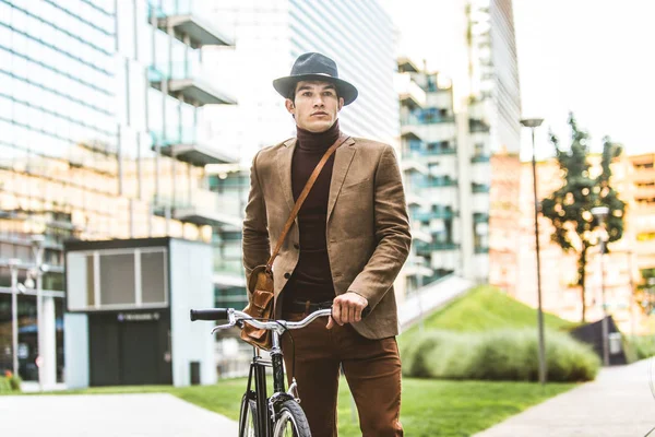 Young handsome man with casual clothes driving bycicle - Young student portrait, concepts about business, mobility and lifestyle