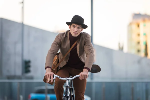 Young handsome man with casual clothes driving bycicle - Young student portrait, concepts about business, mobility and lifestyle