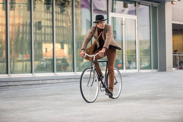 Young handsome man with casual clothes driving bycicle - Young student portrait, concepts about business, mobility and lifestyle